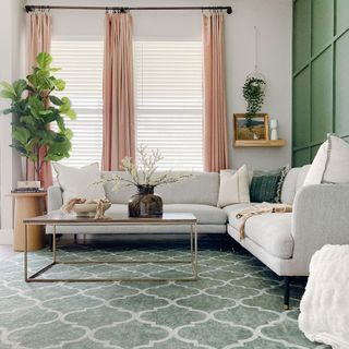 White and green living room with white sofa and green patterned rug