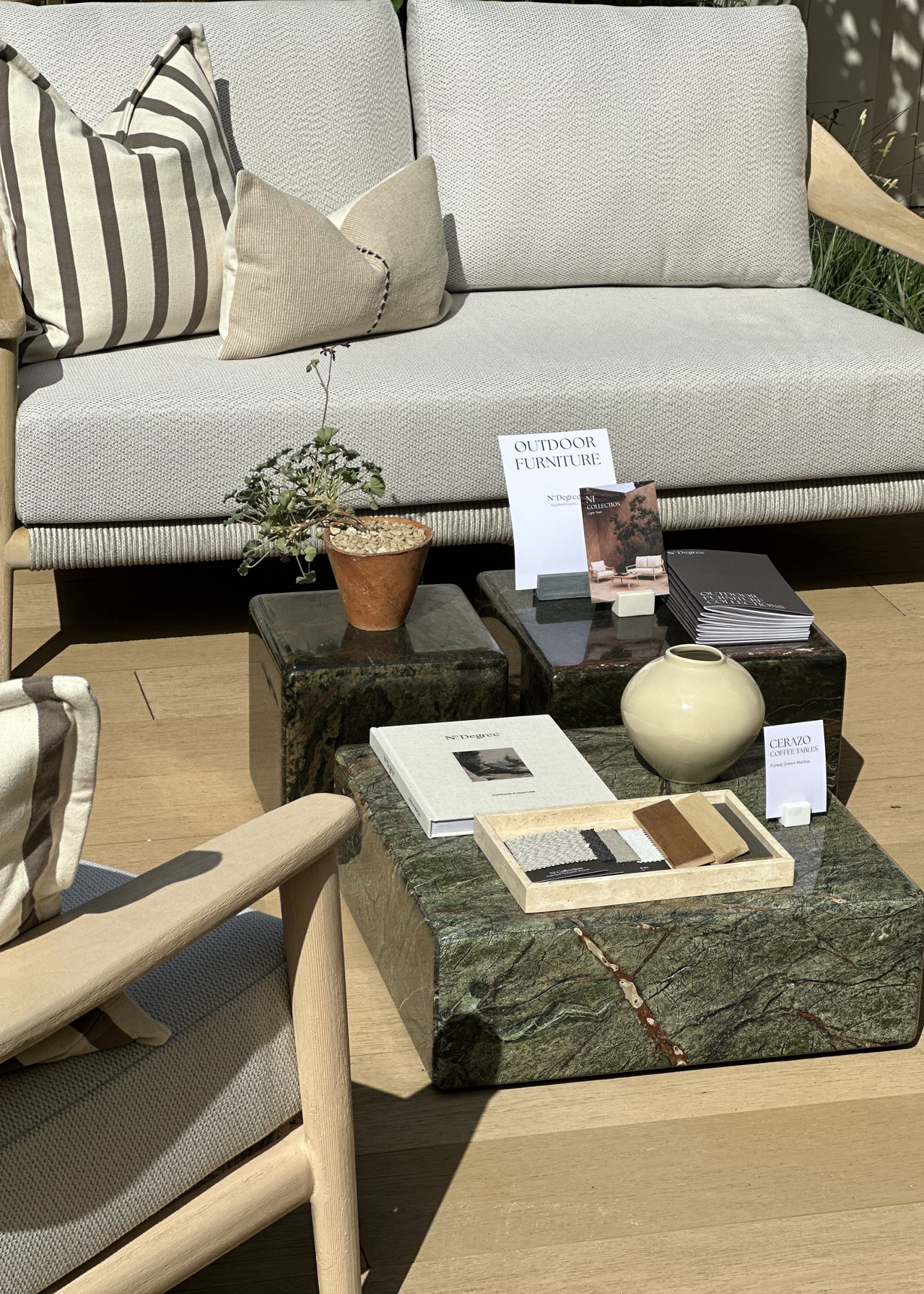 A set of three glossy marble coffee tables by a gray sofa
