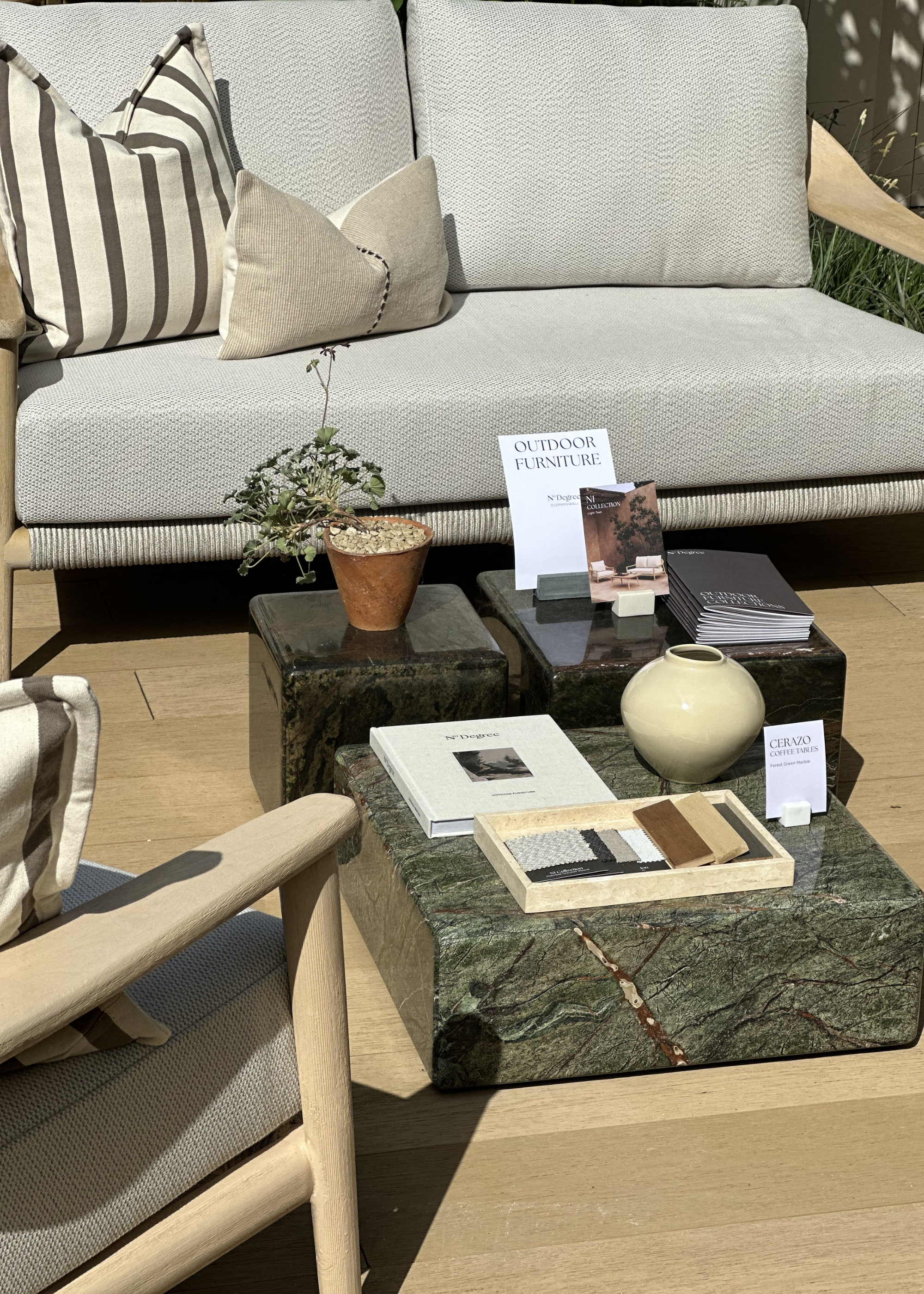 A set of three glossy marble coffee tables by a gray sofa