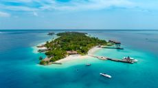 Aerial shot of Maldives island in turquoise lagoon