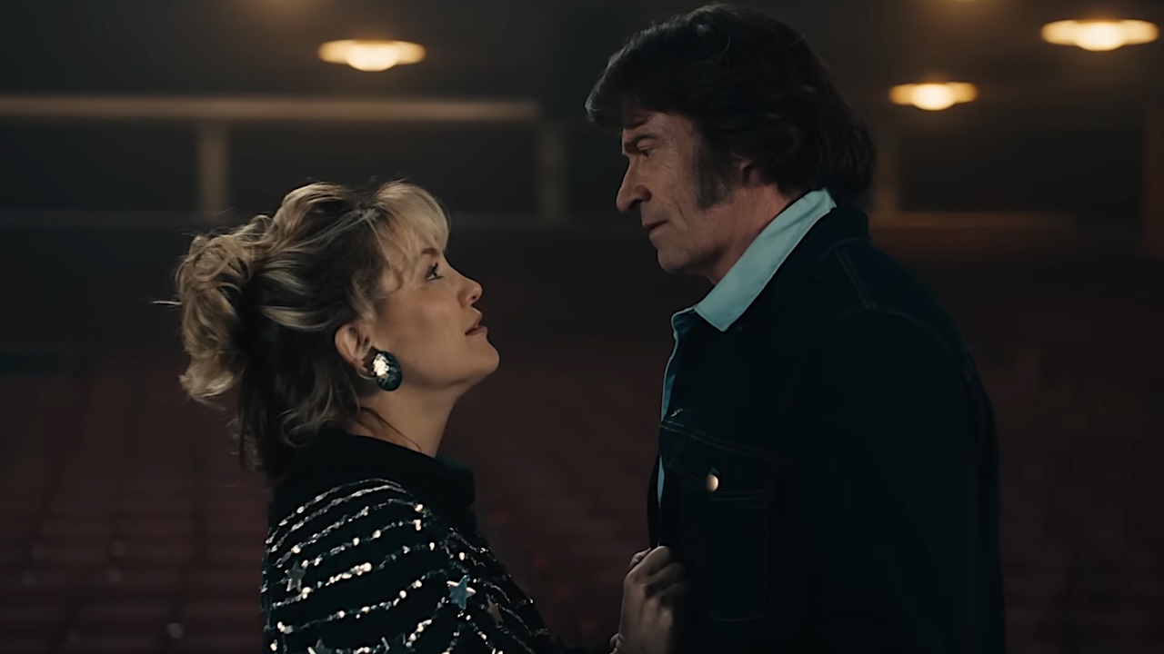 Kate Hudson and Hugh Jackman looking at each other in Song Sung Blue.