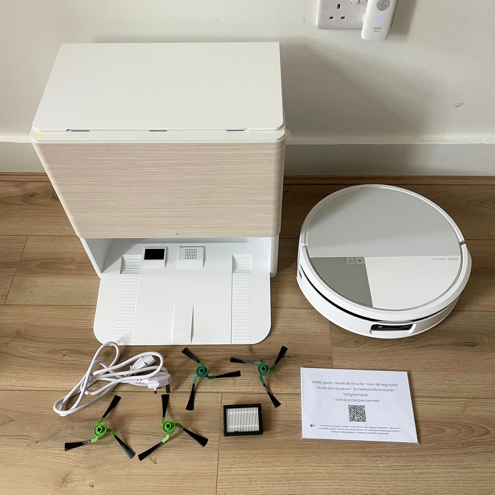 iRobot Roomba Max 705 Combo Robot Vacuum Cleaner and Mop components laid out on wood-effect flooring