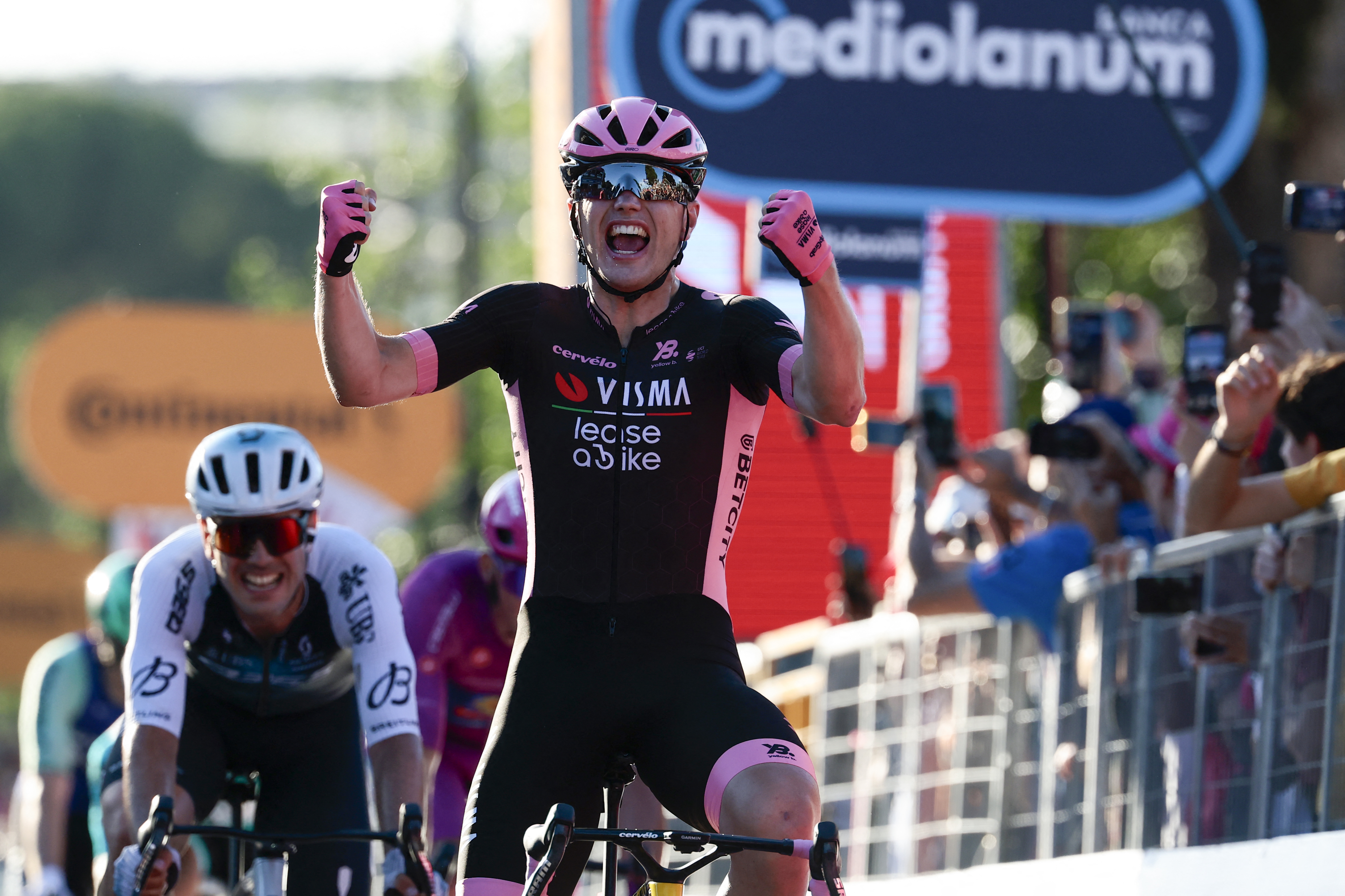 TOPSHOT - Team Visma-Lease a Bike&#039;s Dutch rider Olav Kooij celebrates after victory as he crosses the finish of the 21st and last stage of the 108th Giro d&#039;Italia cycling race of 143kms from Rome to Rome on June 1, 2025. (Photo by Luca Bettini / AFP) (Photo by LUCA BETTINI/AFP via Getty Images)