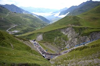 SAINTLARYSOULAN PLA DADET FRANCE JULY 13 A general view of the peloton compete climbing to the Hourquette dAncizan 1566m during the 111th Tour de France 2024 Stage 14 a 1519km stage from Pau to SaintLarySoulan Pla dAdet 1653m UCIWT on July 13 2024 in SaintLarySoulan Pla dAdet France Photo by Dario BelingheriGetty Images