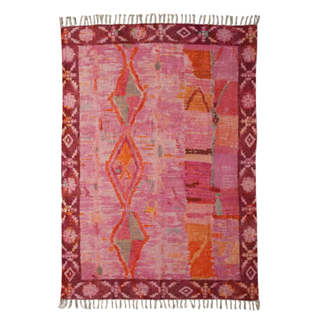 A printed pink and orange chenille rug