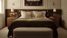 A contemporary bedroom with symmetrical layout, velvet headboard and matching nightstands