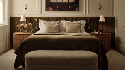 A contemporary bedroom with symmetrical layout, velvet headboard and matching nightstands