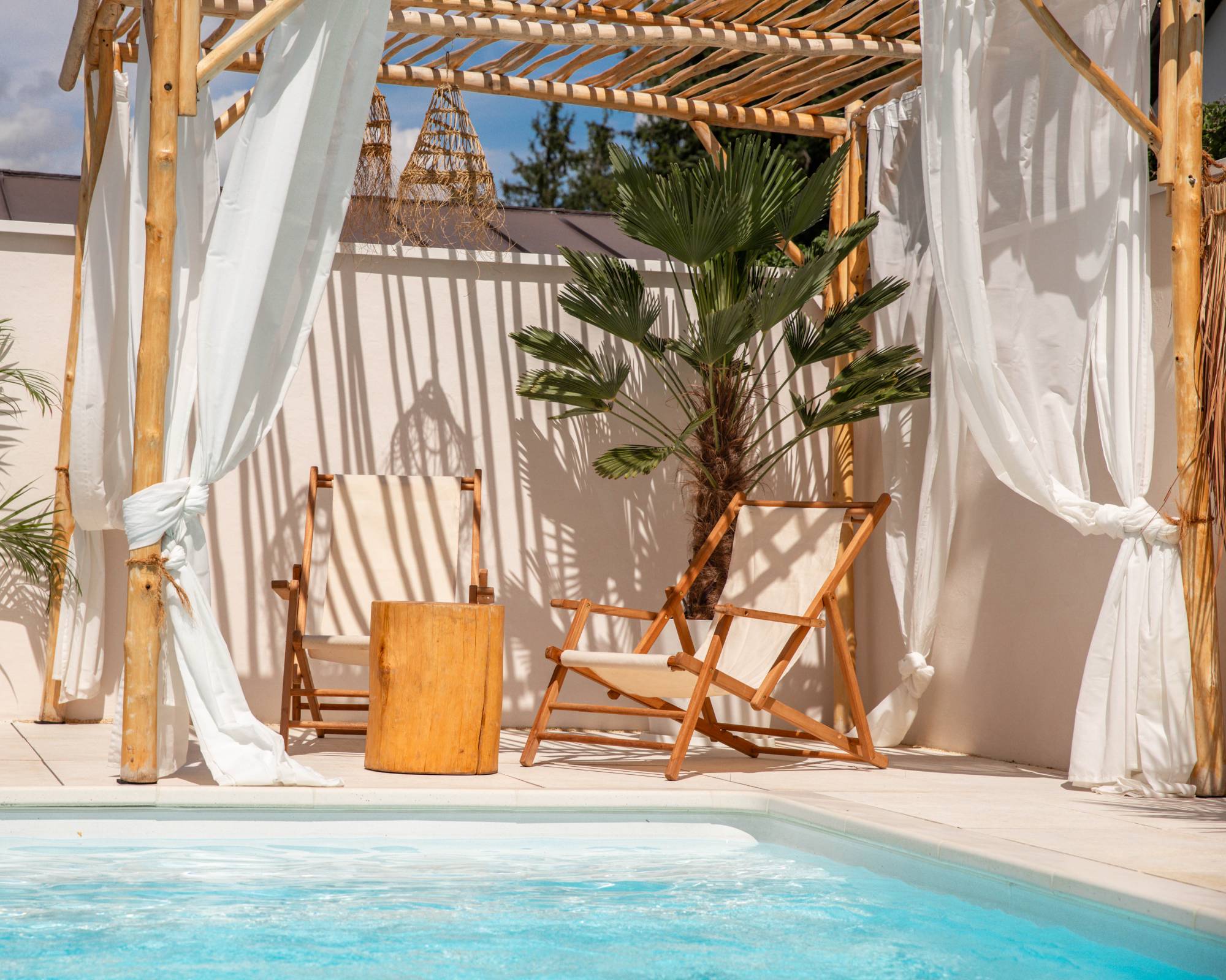 Mosquito net curtains on gazebo next to pool
