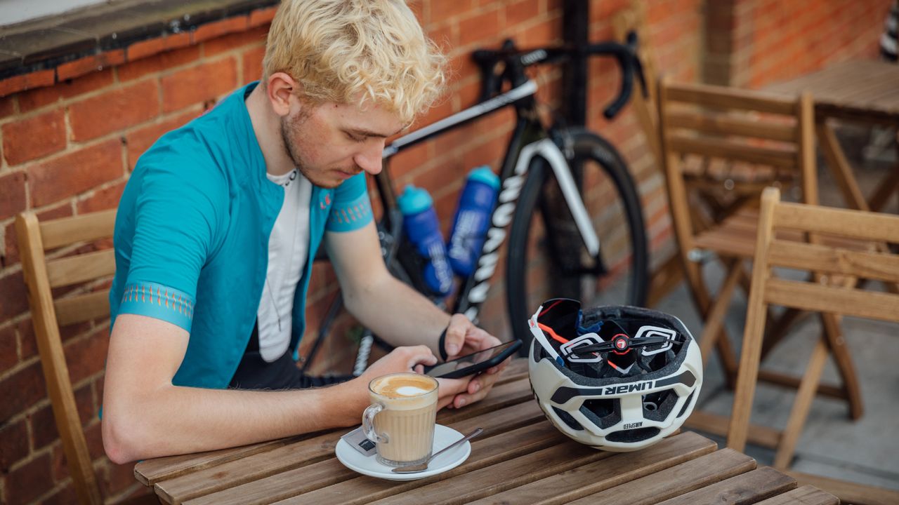 Image shows a rider looking at the Stava app.