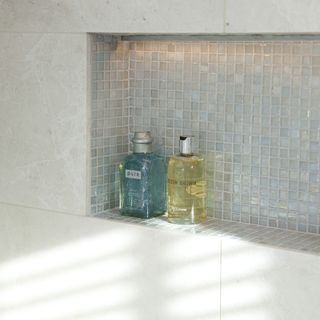 grey tiles wall liquid bottles and led light