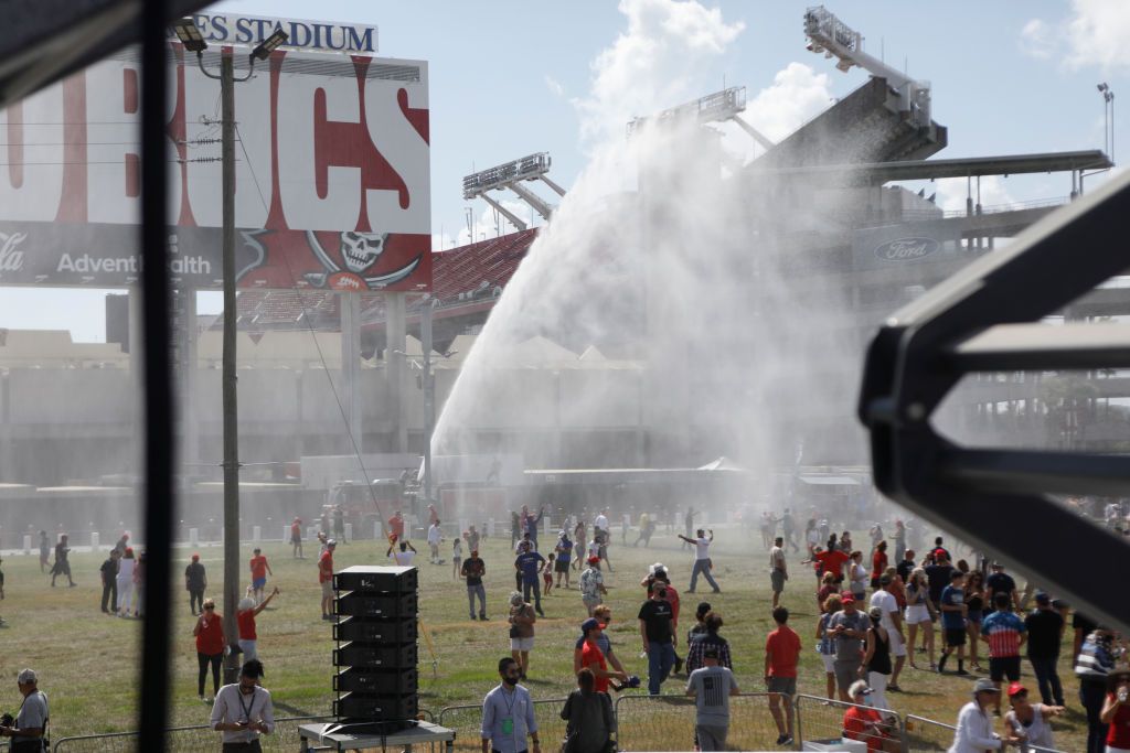 Fire crews spray Trump supporters with water at his Tampa rally.