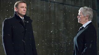 Daniel Craig and Judi Dench standing in the snow in Quantum of Solace.