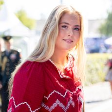 Princess Catharina Amalia wearing a red top and smiling
