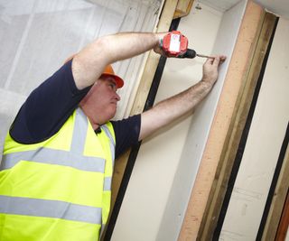 man insulating internal wall