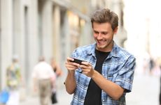 Man playing game with a smart phone