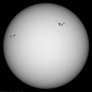 Sunspots seen on the disk of the Sun in white light. Sunspots are formed in active regions, and their magnetic fields are the source of solar flares and CMEs