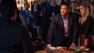 Will Smith and Margot Robbie stand at a poker table in Focus