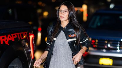 Bella Hadid in a gray knit set and black leather jacket