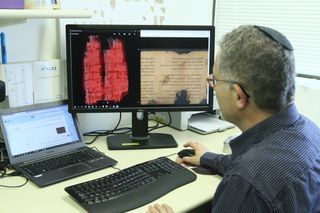 Jonathan Ben-Dov of the University of Haifa studies the Dead Sea Scroll.