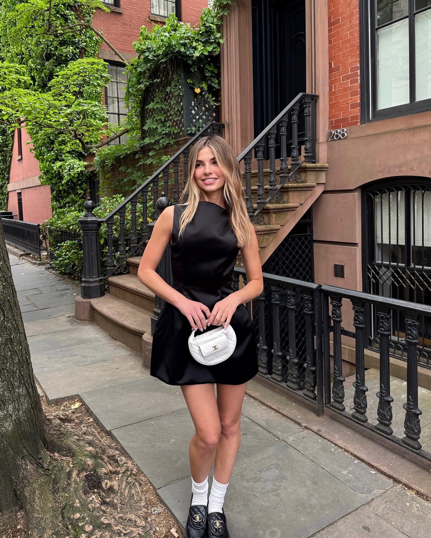 Influencer wearing a flared mini dress and flat shoes