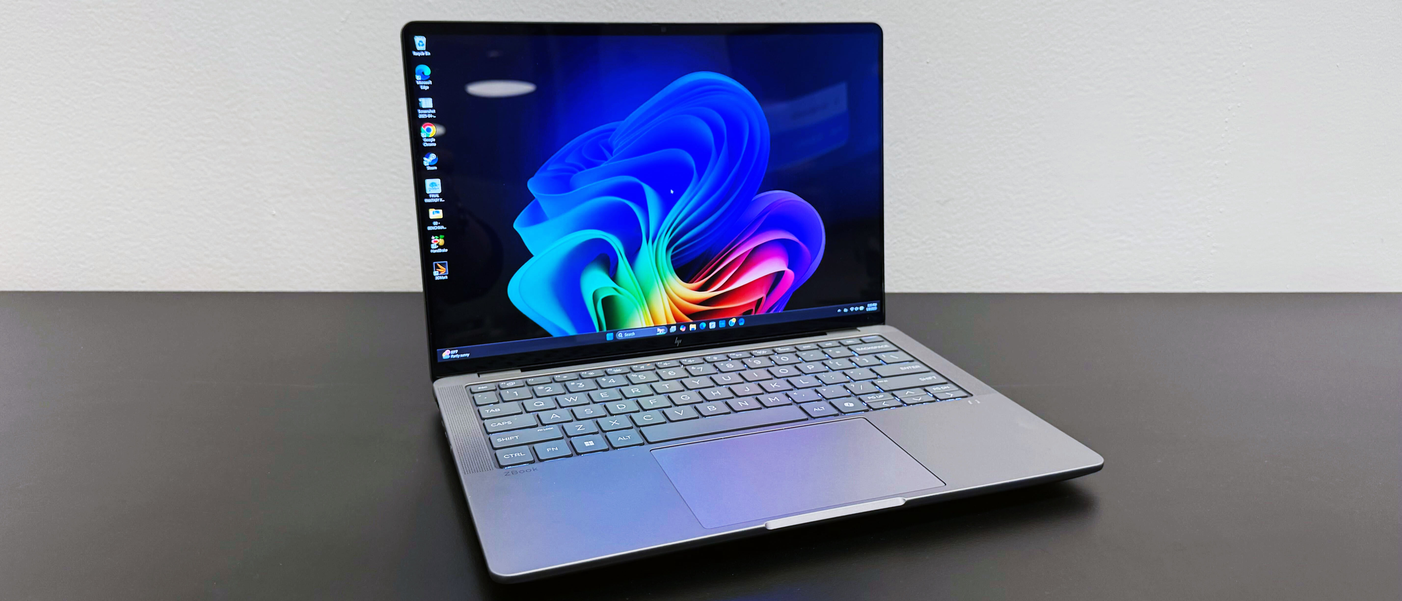 The HP ZBook Ultra 14 G1a mobile workstation open on a black desk against a white wall.