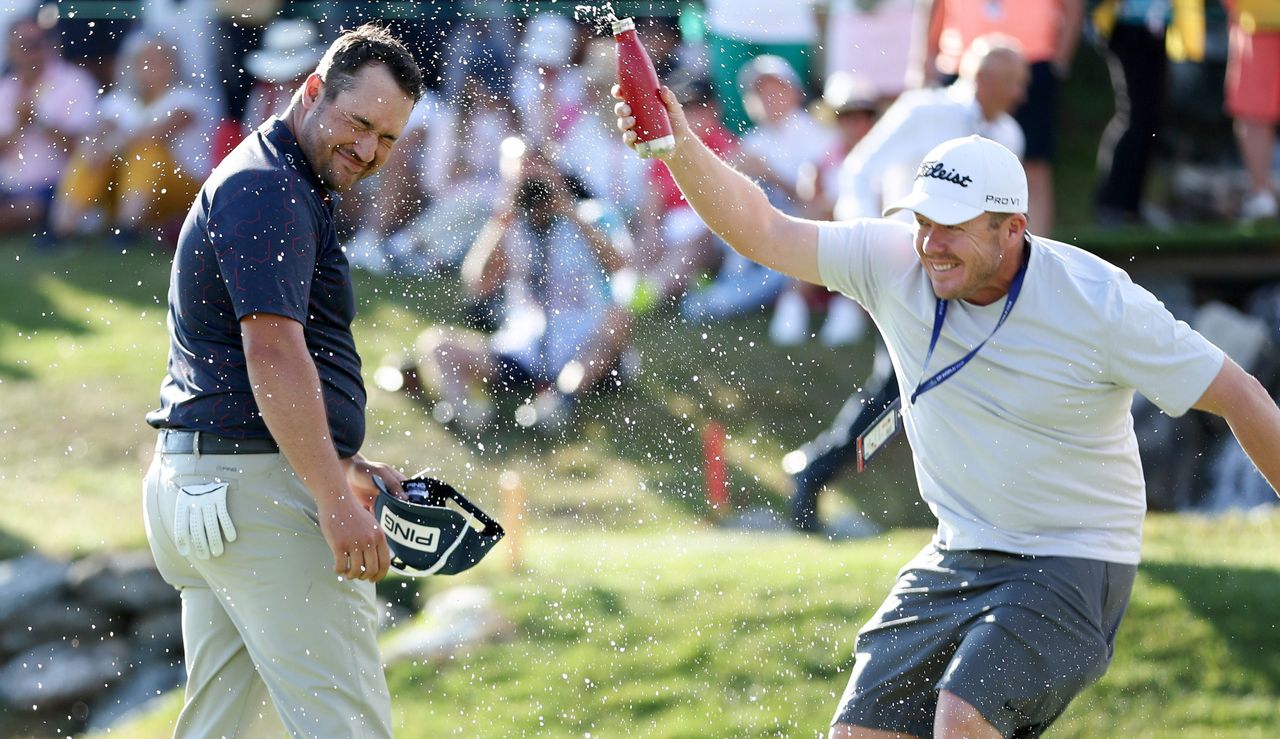 Lawrence gets covered in water by his friend after claiming victory