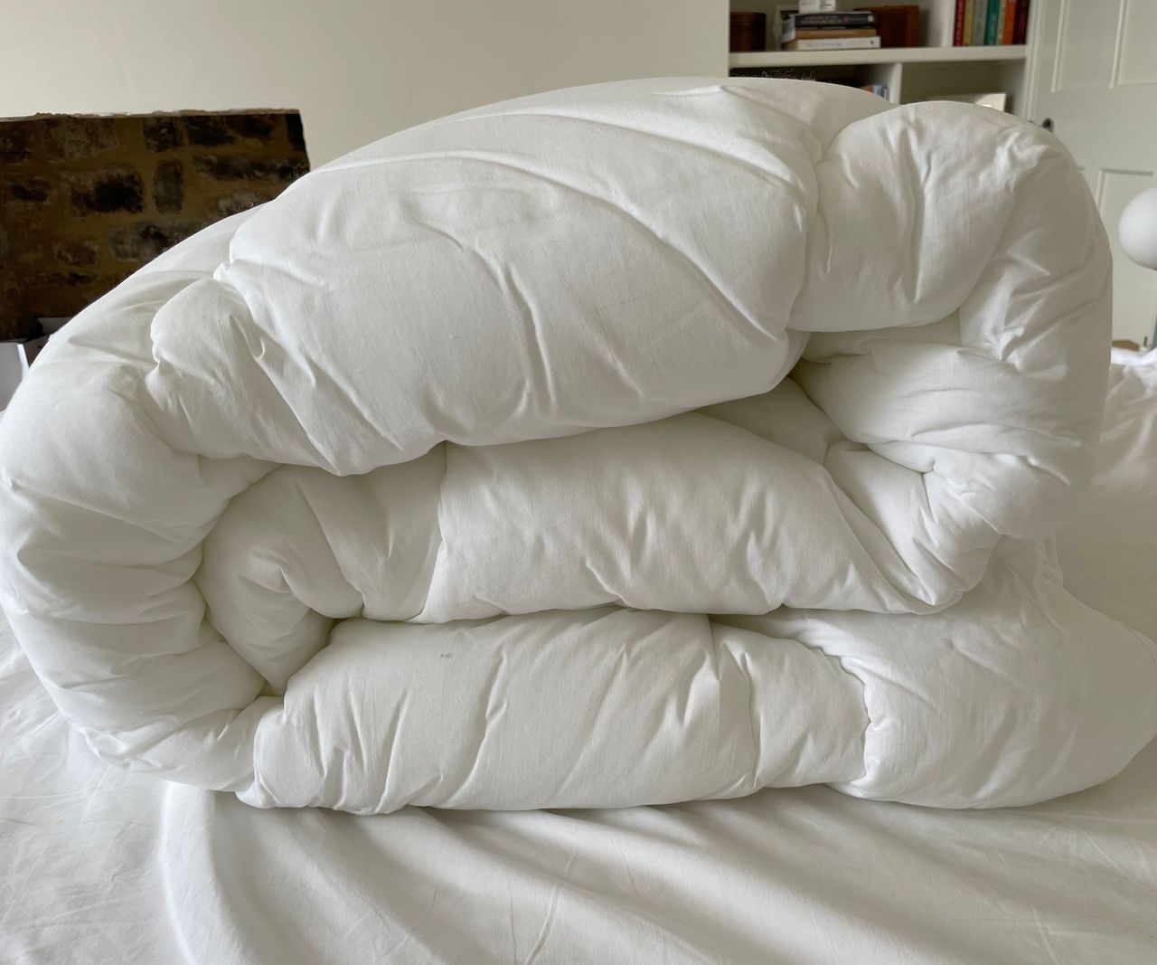 M&amp;S Comfortably Cool Mattress Topper rolled up on the bed
