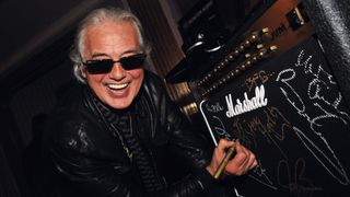 Jimmy Page signs a Marshall amp at the Classic Rock Awards afterparty in London, November 2, 2009