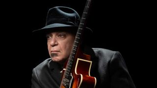 Chris Goss holding a guitar