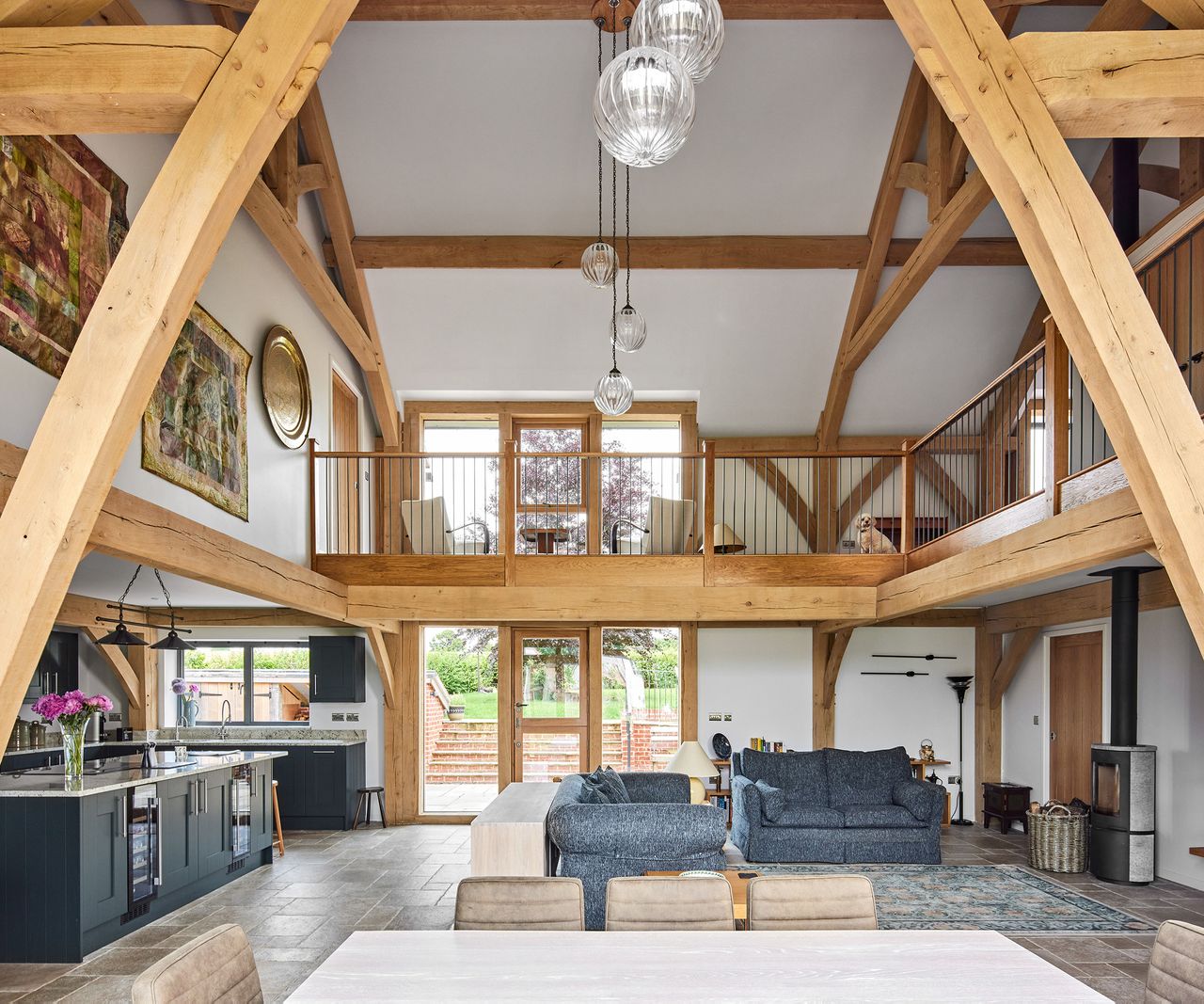 A double height oak-frame home with a beautiful open atrium over an open plan ground floor living, dining and kitchen area