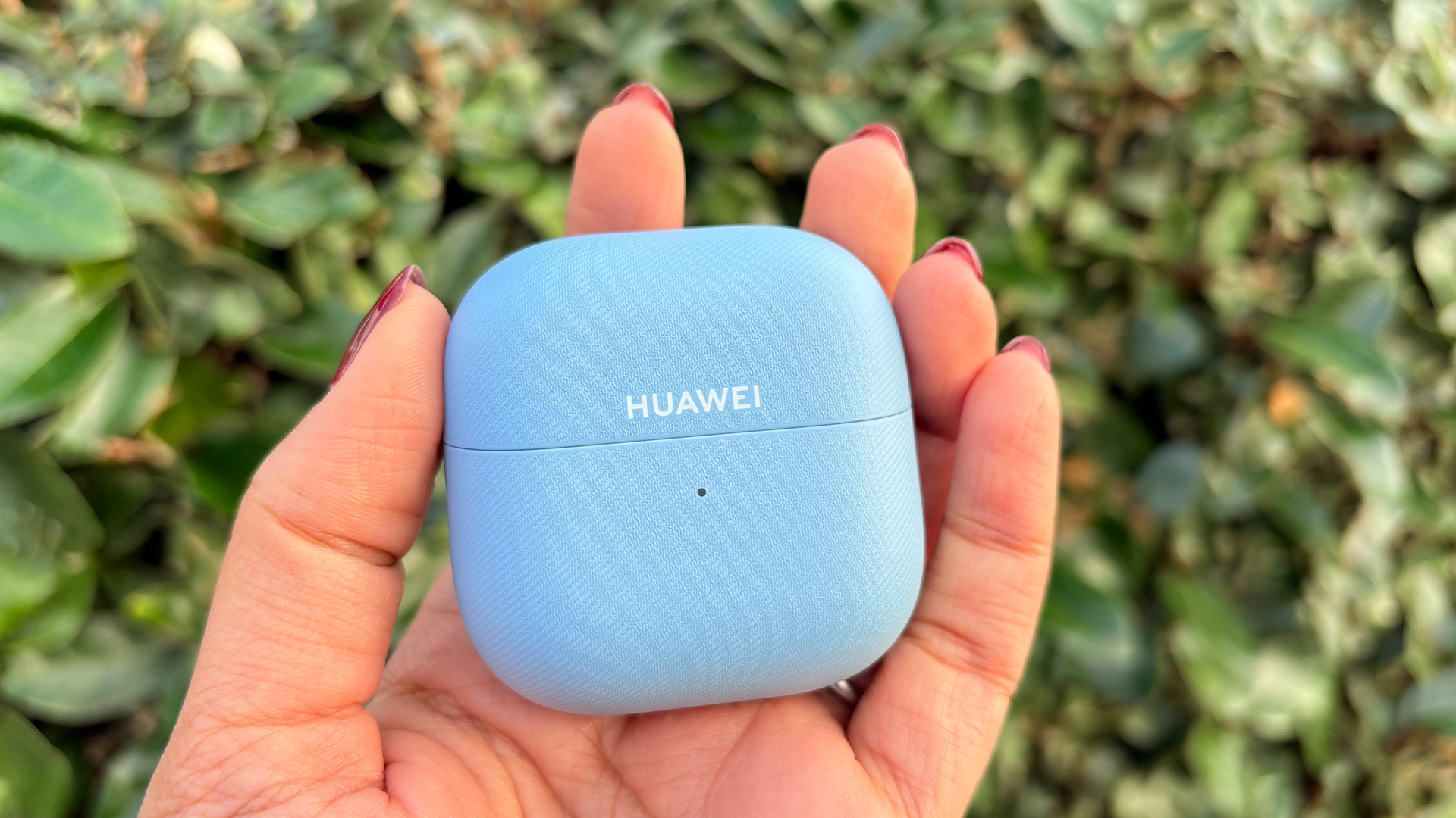 Huawei FreeClip 2 wireless earbuds charging case held in hand