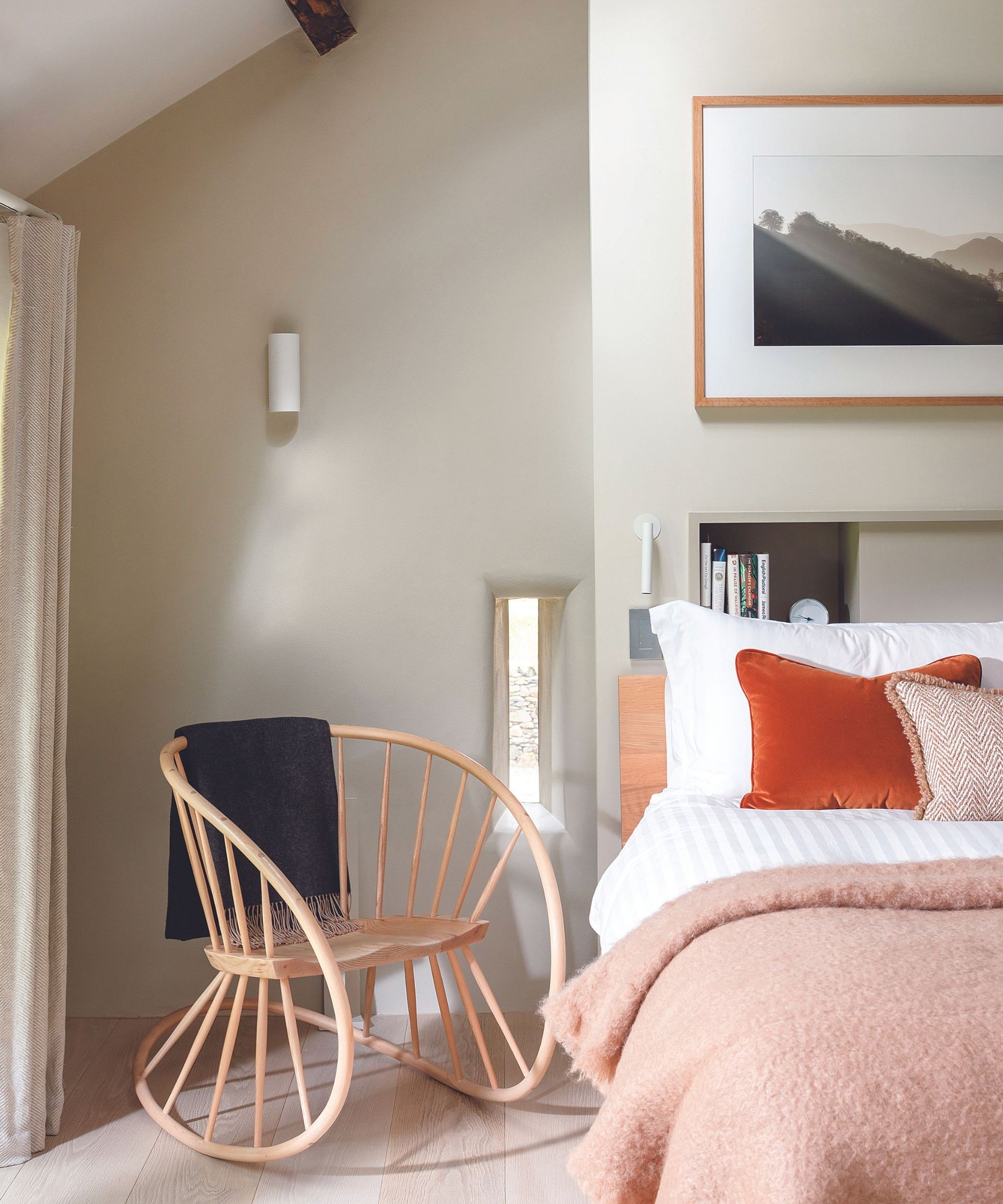 Pink blanket, wooden rocking chair, shelf