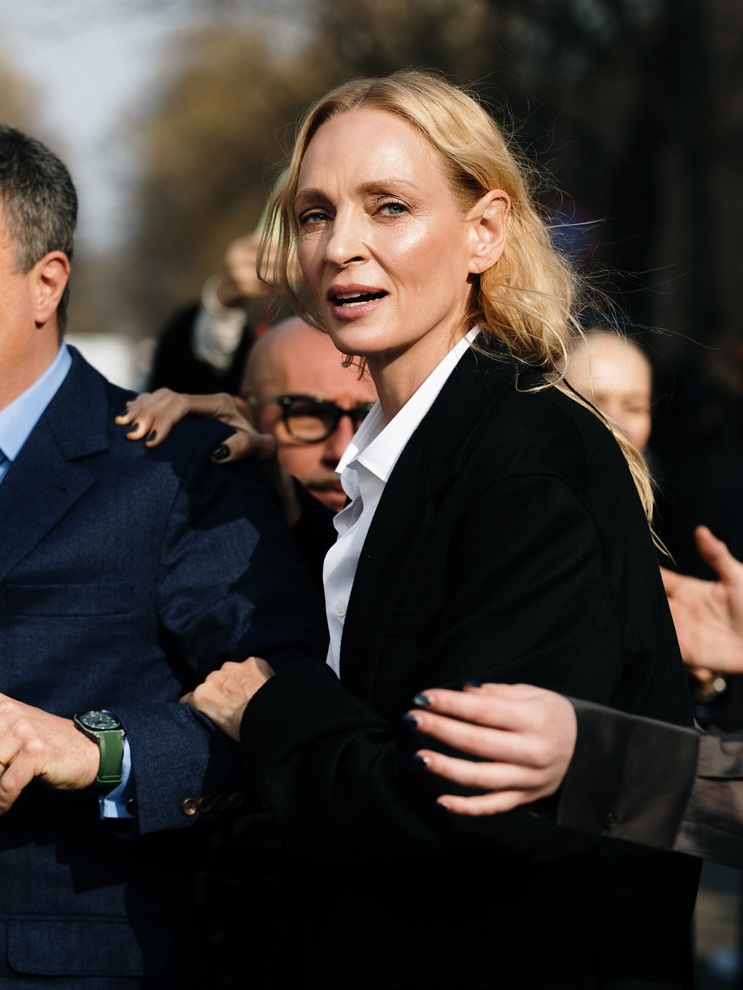 a blonde woman with glowing skin in a black jacket