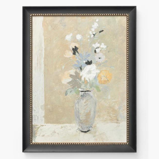 A framed painting of a vase of flowers.