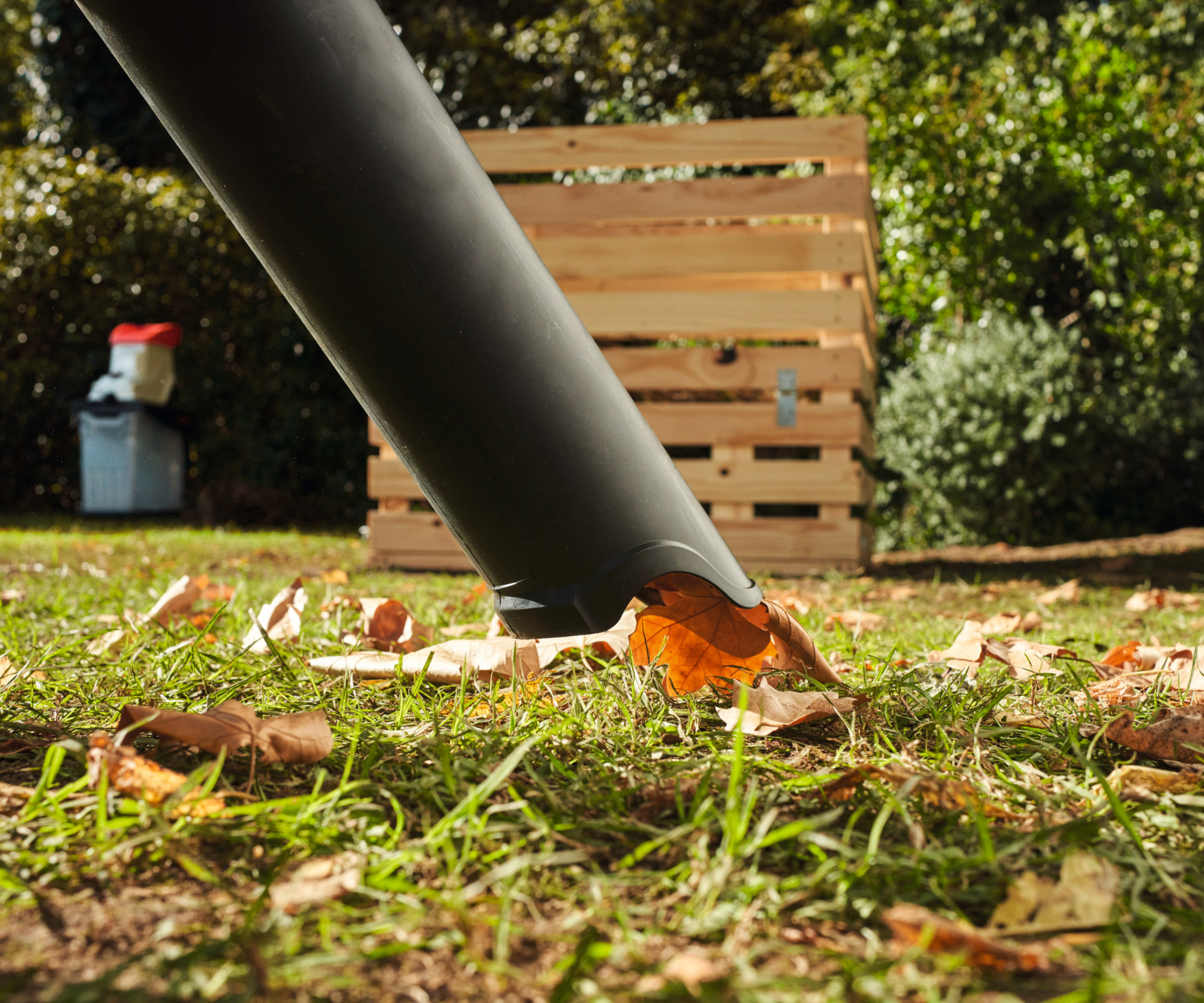 Leaves on lawn being vacuumed by Stihl leaf blower