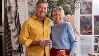 John and Lisa standing at a table for John and Lisa's weekend kitchen season 9