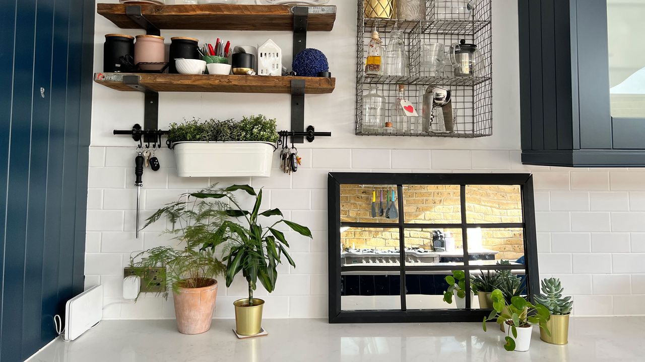 Crittal-style mirror propped up on floor with shelving