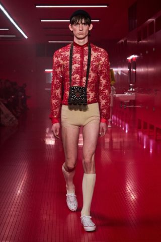 A model in the F/W 25 Valentino show wearing Vans Valentino collaboration checkerboard sneakers.