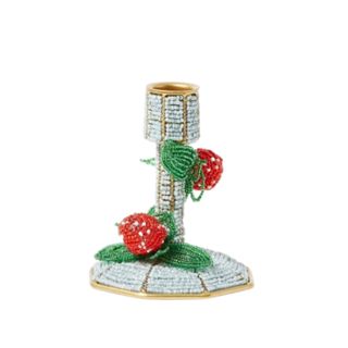 A blue beaded candle holder with strawberry decorations
