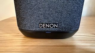 Denon Wireless Speaker 150 close up of the Denon logo on the front of the speaker