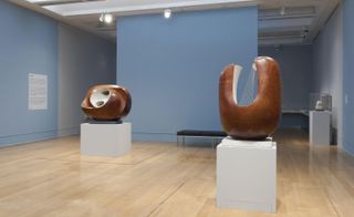 Two American hardwood sculptures on display in an art exhibition.