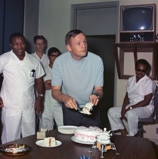 Apollo 11 astronaut Neil Armstrong cuts his birthday cake while in quarantine at the Crew Reception Area of the Manned Spacecraft Center, on Aug. 5, 1969 — 11 days after the Apollo 11 crew returned to Earth.