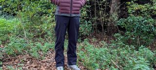 Hiker wearing Salomon Outerpath 2.5L rain pants