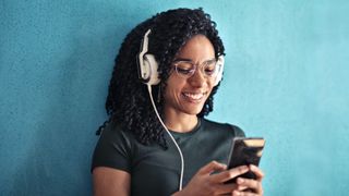 Woman listening to music on smartphone