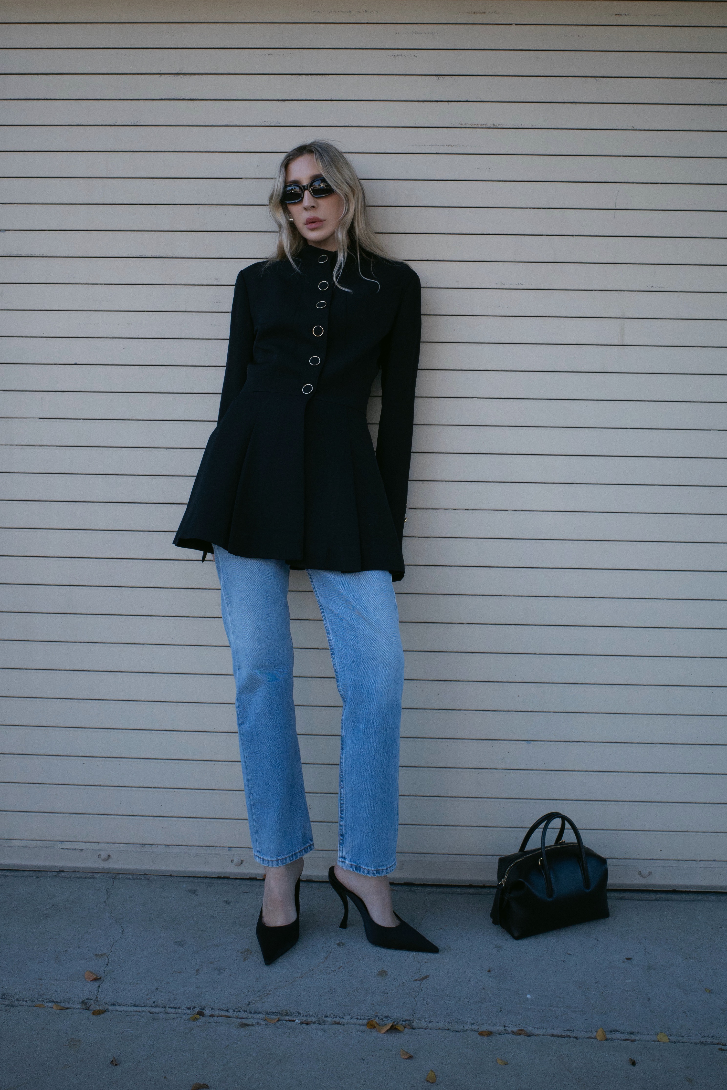 Angela Fink wearing a jacket, jeans, and heels
