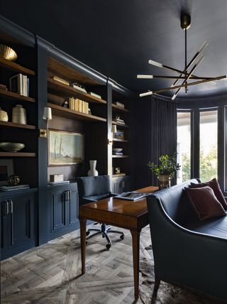 dark blue home office with sofa by Marie Flanigan