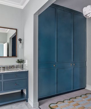 Bathroom dressing room with blue closet and blue vanity