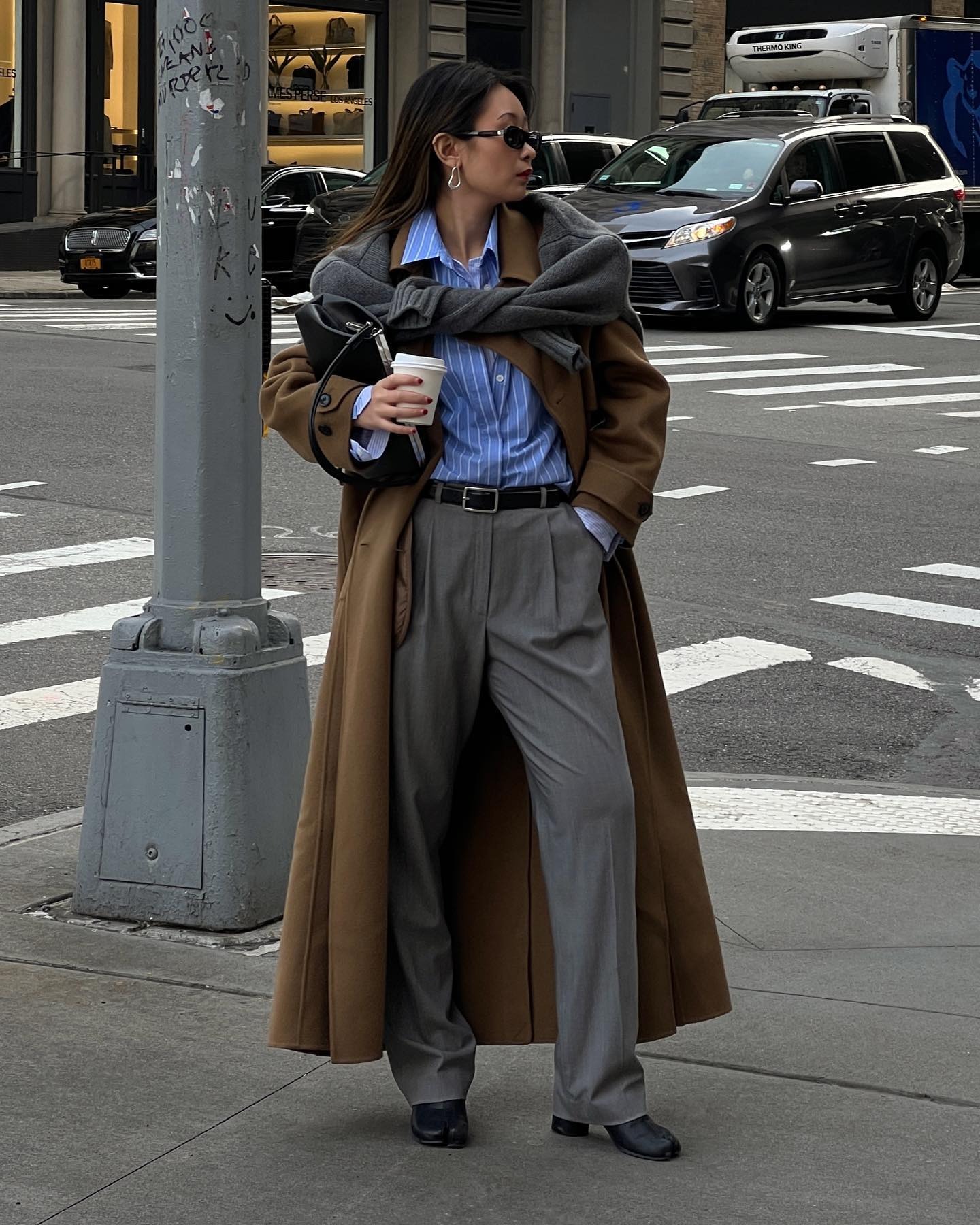 Woman wearing fall outfit with black ankle boots.