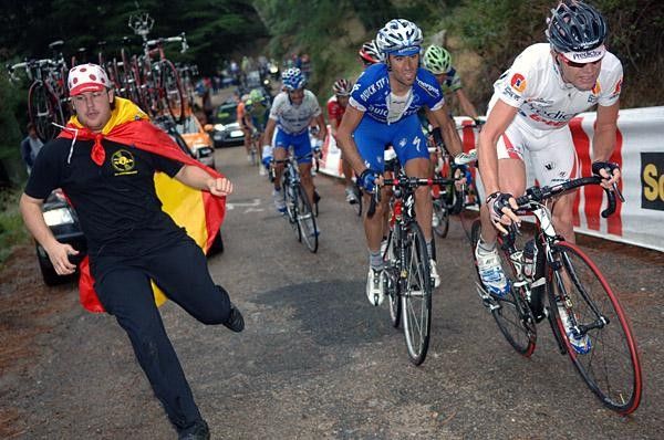 Cadel Evans gets encouragement from a fan, but no help from Carlos Barredo