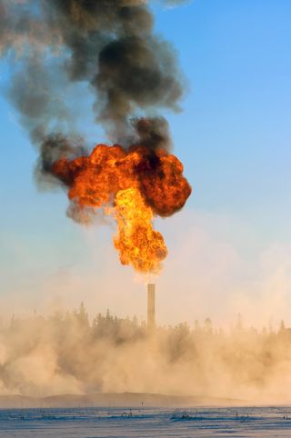 Waste gas is flared, or burnt off, during oil production, as shown above. This is process emits carbon dioxide, the most prominent greenhouse gas. 